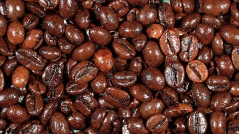 Top Down Hard Light Rotating Roasted Coffee Beans Texture Video stock 331935841