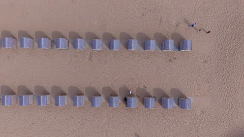 Top down horizontal aerial drone video clip of beach cabins, wooden huts Видео 342740092
