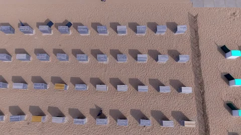 Top down horizontal aerial drone video clip of beach cabins, wooden huts Vidéo 342818726
