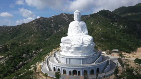 Top Down Huge Buddha Temple Sculpture on Mountain Side Aerial Drone Shot Stock Footage 122232723