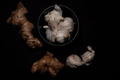 Top down image of a collection of garlic and ginger in dark copy space backgr Stock Photos