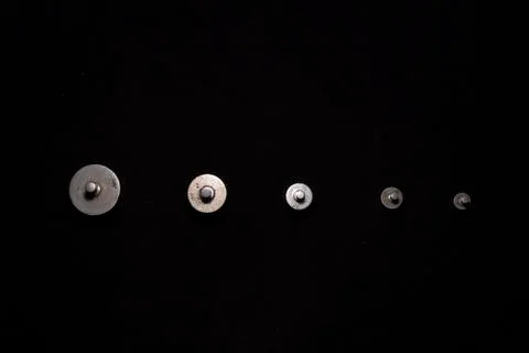 Top down image of different weights are arranged in descending order in a dar Stock Photos