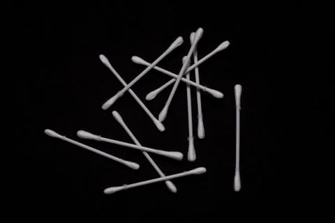 Top down image of ear buds scattered in a dark copy space background. Object  Stock Photos