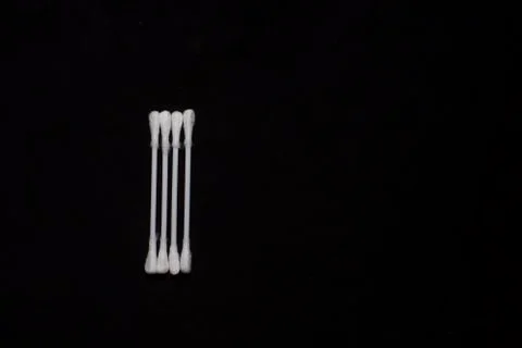 Top down image of ear buds arranged in an order in a dark copy space backgrou Stock Photos
