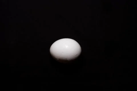 Top down image of an egg in a dark copy space background. Food and product ph Stock Photos