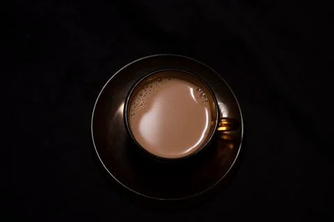 Top down image of infused tea in a transparent glass cup and soccer kept in b Stock Photos