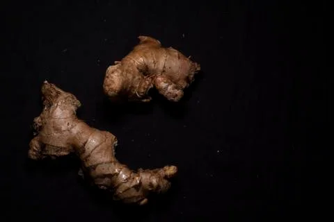 Top down image of pieces of ginger in a dark copy space background. Food and  Stock Photos