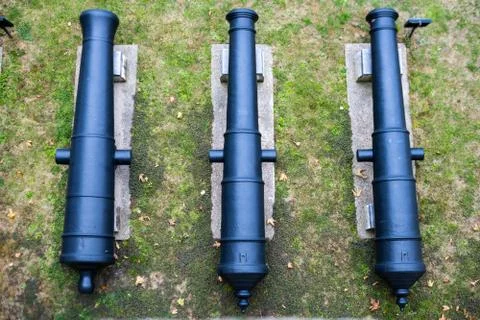 Top down image of three cannons in a row outside the Tower of London, UK Stock Photos