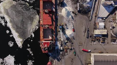 Top down industrial harbor activity with cargo ship winter Stock Footage 329452393