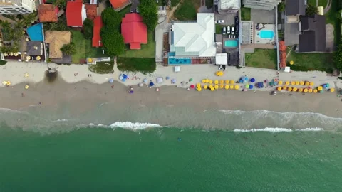 Top Down Ingleses Beach with Umbrellas and Atlantic Waves Stock Footage 333393825