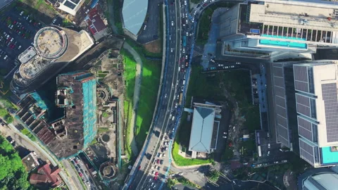 Top-down Kuala Lumpur highway, canal and towers under bright tropical sun Stock Footage 327123474