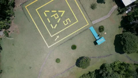 Top Down Looking At Helipad, Pans up Island Seeing Beachfront Homes, 4k Stock Footage 239686122