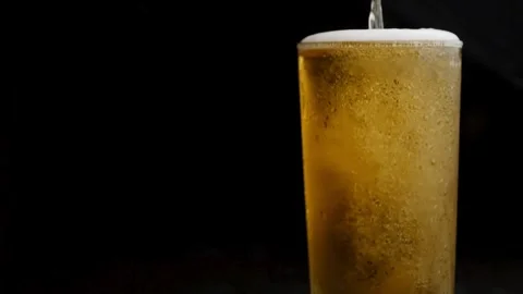 Top-down macro super slow motion studio shot with copy space. pouring a beer Stock Footage 265837130