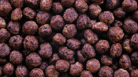 Top down macro view. Heap of crunchy breakfast corn flakes, dry cereal balls. Stock Footage 296567819