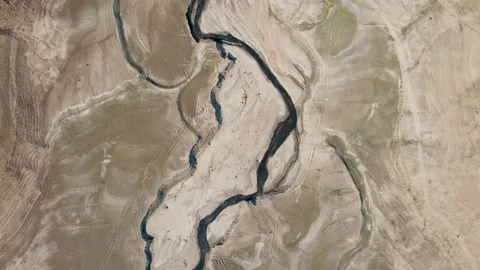 Top down of many cracks in surface of dry lake. 4K Video Stockbeeldmateriaal 166109285