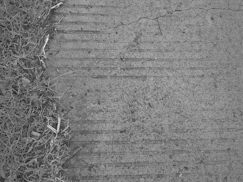 A top down monochrome view captures a grooved concrete floor surface border.. Stockfoto's