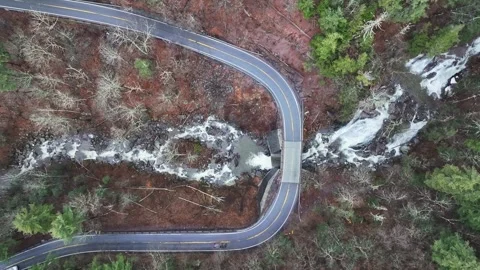 Top down of a Mountain Road over a Waterfall 4K Stock Footage 268843504