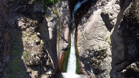 Top down of narrow rock crevice with mountain waterfall stream in Kazakhstan Видео 337672337