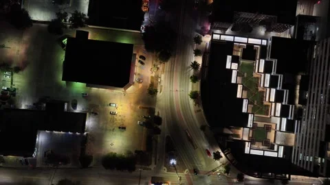 Top Down Night Aerial over Dallas Streets and Lit Parking Courts Stock Footage 343072156
