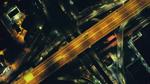 Top down night city roads: cars driving aerial. Nightly urban cityscape, modern Stock Footage