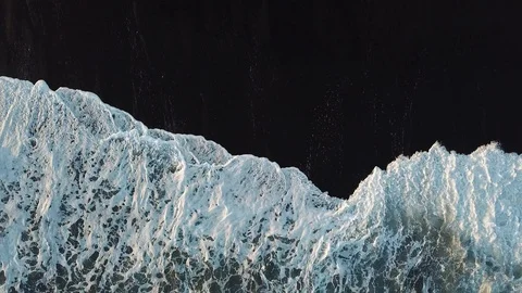 Top down of ocean tide wave on black sand in Iceland Stock Footage 98156499