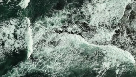 Top down ocean waves via drone crashing blue water against the shore Stock Footage 282733940