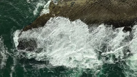 Top down ocean waves via drone crashing blue water against the shore Stock Footage 282739561