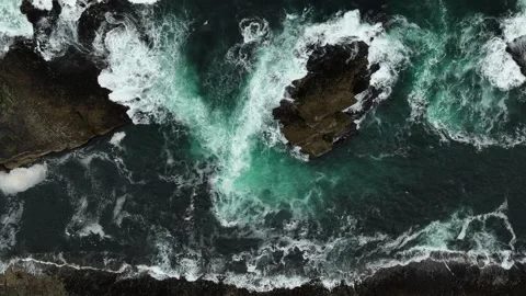 Top down ocean waves via drone crashing blue water against the shore Stock Footage 282739575