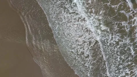 Top Down Ocean Waves Rolling on Sand Shoreline 4K Stock Footage 344314299