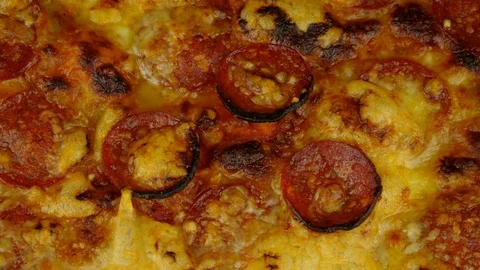 Top down of an oven cooked pepperoni and cheese pizza. Rotating. Stock Footage 116589660