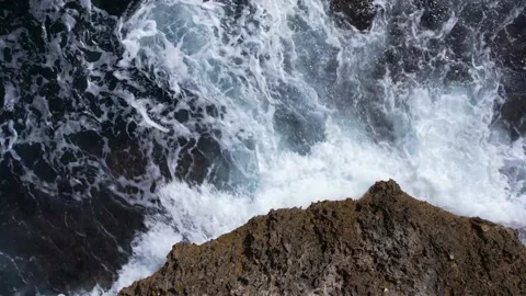 Top Down over Waves crashing on the rocks, Cliffs of Majorca, Spain, Europe Stock Footage 217439843