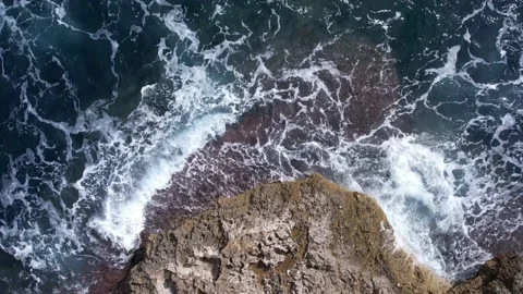 Top Down over Waves crashing on the rocks, Cliffs of Majorca, Spain, Europe Stock Footage 217439877