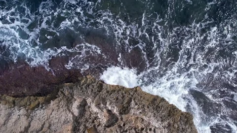 Top Down over Waves crashing on the rocks, Cliffs of Majorca, Spain, Europe Stock Footage 217439999