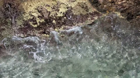 Top Down over Waves crashing on the rocks, Cliffs of Majorca, Spain, Europe Stock Footage 217440939