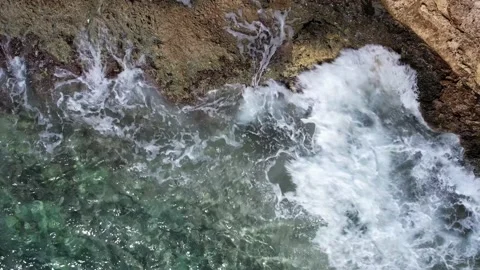 Top Down over Waves crashing on the rocks, Cliffs of Majorca, Spain, Europe Stock Footage 217441106