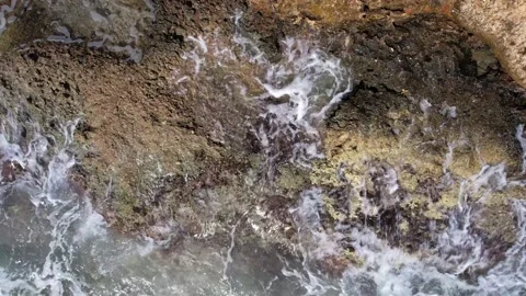 Top Down over Waves crashing on the rocks, Cliffs of Majorca, Spain, Europe Stock Footage 217441308