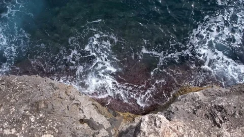 Top Down over Waves crashing on the rocks, Cliffs of Majorca, Spain, Europe Stock Footage 217590269