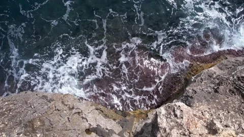 Top Down over Waves crashing on the rocks, Cliffs of Majorca, Spain, Europe Stock Footage 217591231