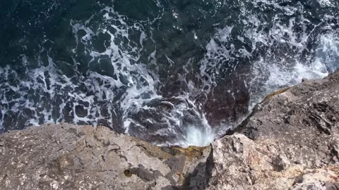 Top Down over Waves crashing on the rocks, Cliffs of Majorca, Spain, Europe Stock Footage 217591273