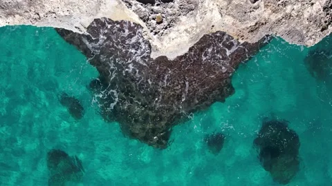 Top Down over Waves crashing on the rocks, Cliffs of Majorca, Spain, Europe Stock Footage 217609697