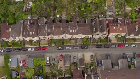 Top-down overhead aerial tracking along traditional English houses, gardens and Vídeos de archivo 144782710