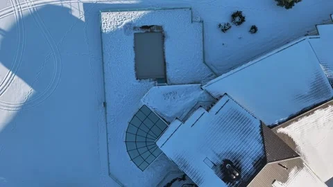 Top-down panning drone fly over snow covered rooftops and geometric patterns in 動画素材 333781914