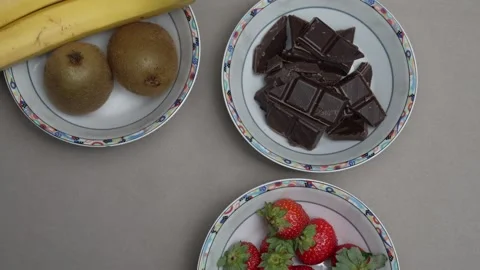 A top down panning shot of the uncut ingridients for a chocolate fondue Stock Footage 346238207