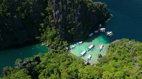 Top Down Parallax Above Outrigger Tour Boats at Barracuda Lake Coron Palawan Stock Footage 336321750