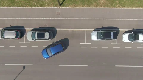 TOP DOWN: Person tries to parallel park their car into a tight roadside spot. Stock Footage 142741325
