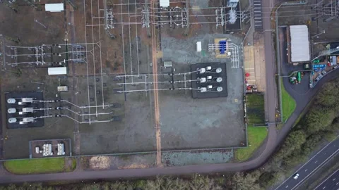 Top down perspective of powerlines crossing through an industrial electrical Stock Footage 336708316
