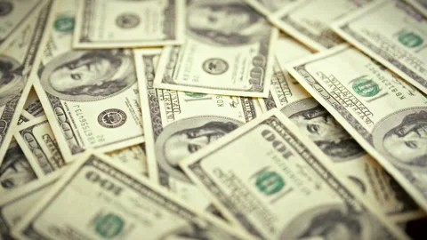 A top-down perspective reveals a backdrop of vintage dollar bills framing a Stock Footage 346390305