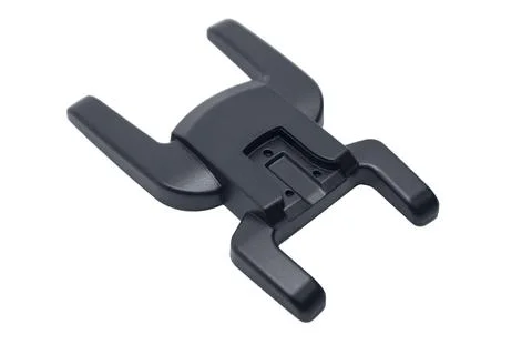 A top-down perspective view of a black plastic camera flash hot shoe adapte.. Stock Photos