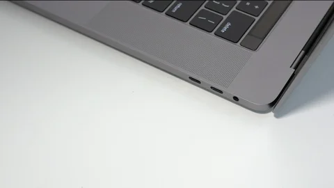 Top down, plugging in a white USB-C / Type C cable to a modern notebook Stock Footage 95126635