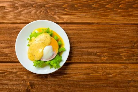 Top down poached eggs, ham, lettuce leaf and delicious buttery fresh hollanda 写真素材